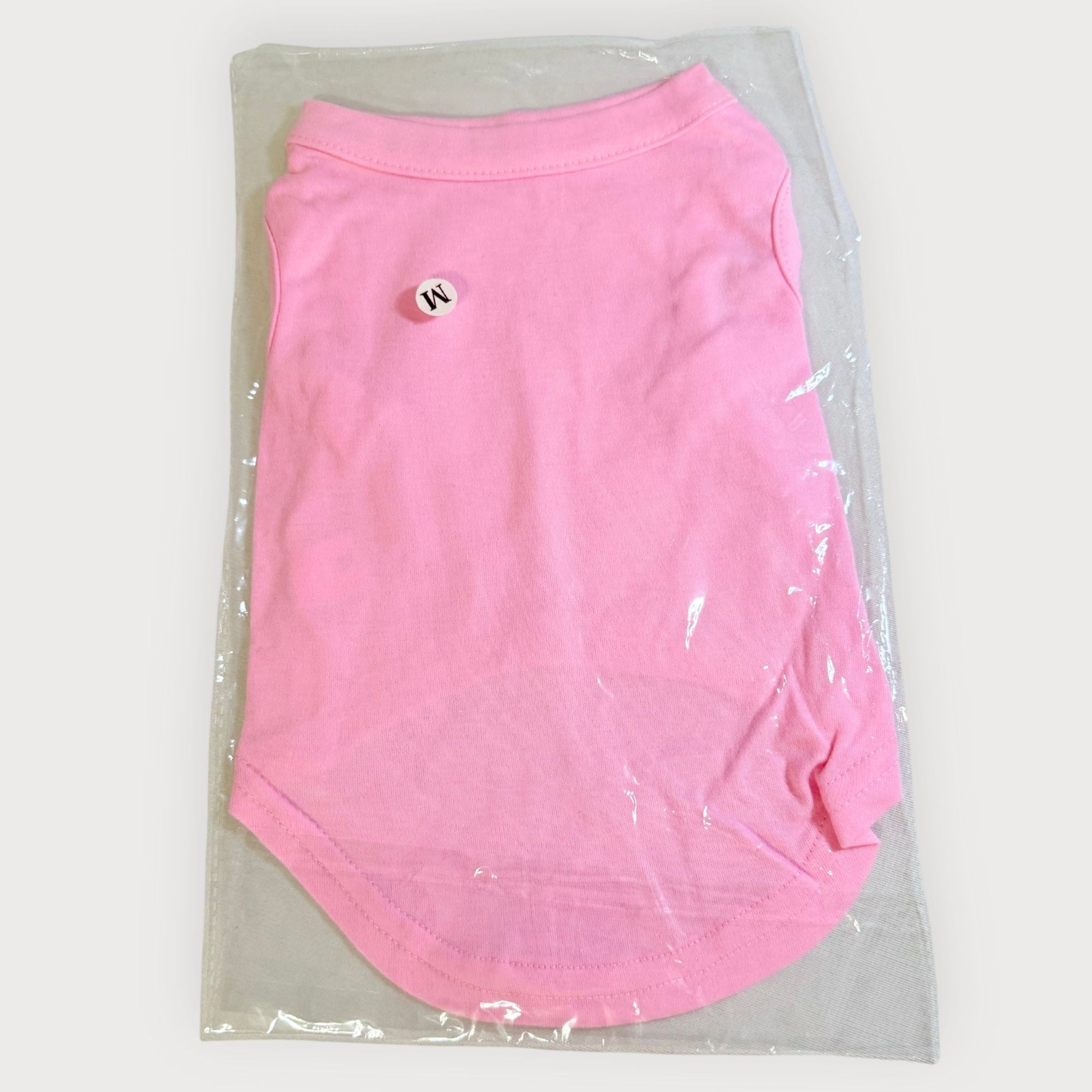 Folded pink blank dog shirt packaged in clear plastic, ready for creators and pet boutiques.
