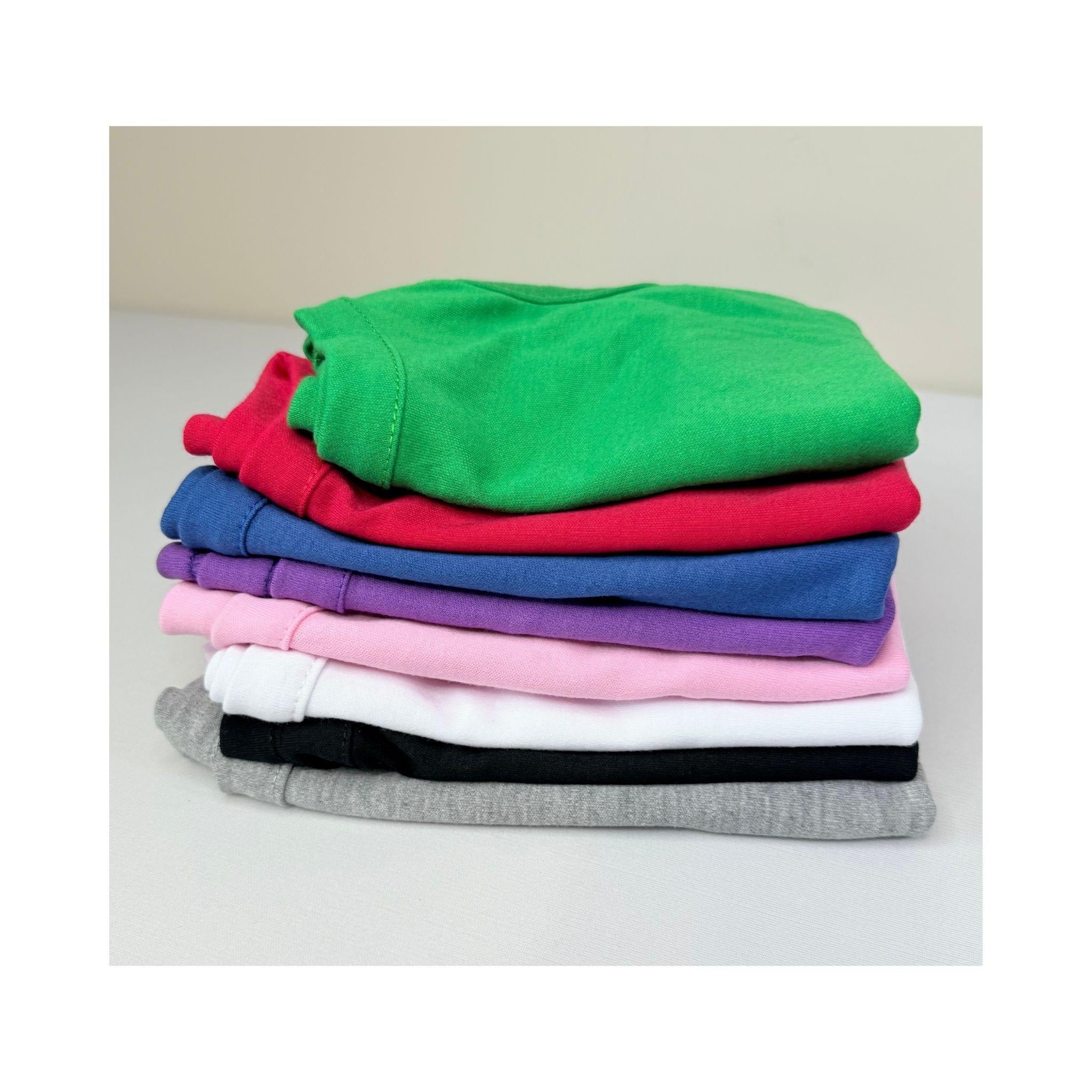 Stack of blank dog t-shirts in assorted colors including green, red, purple, pink, white, black, and gray – wholesale blank pet clothing for customization
