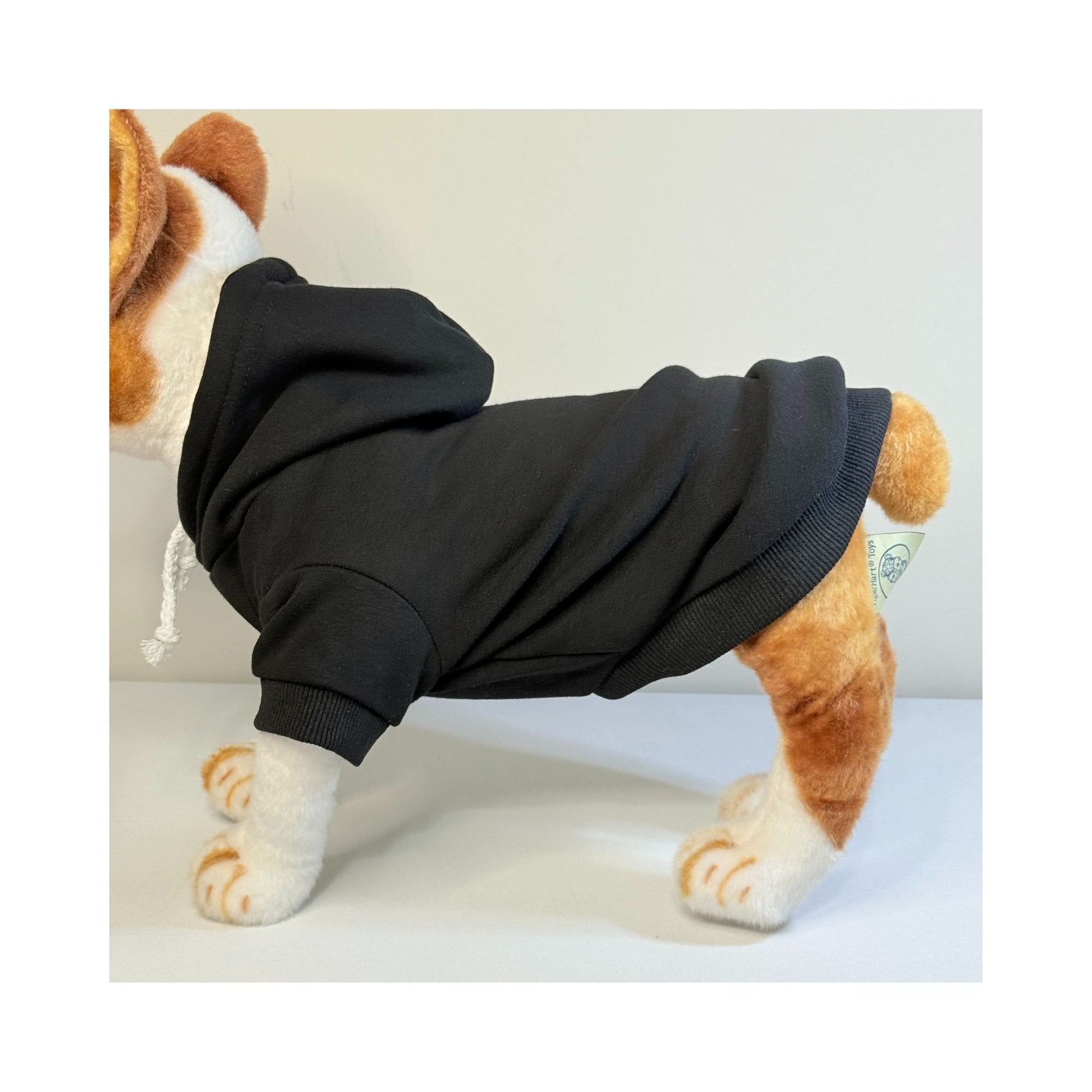 Side view of a stuffed dog mannequin wearing a black blank dog hoodie - showcasing fit, sleeve length, and full body coverage for small breeds.