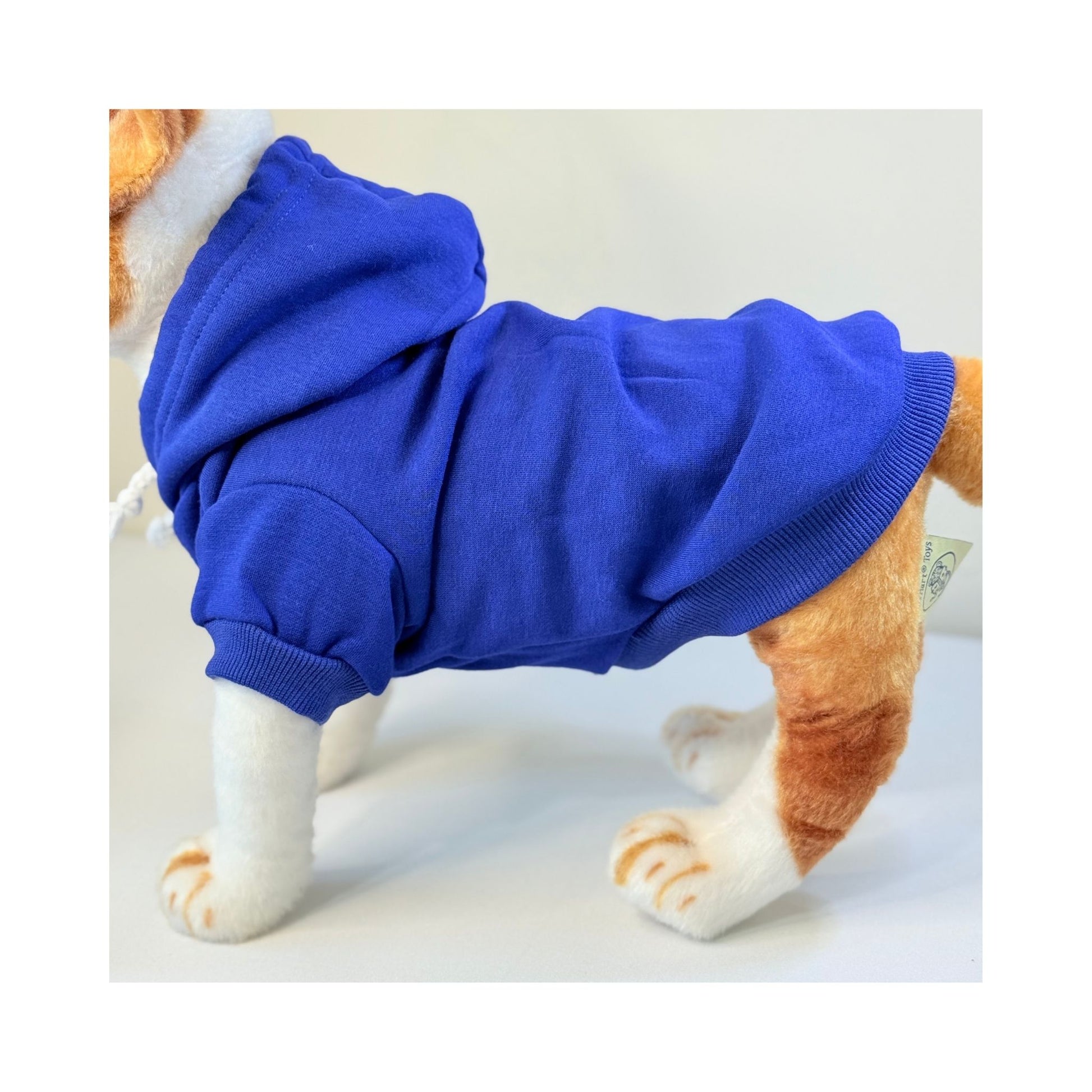 Side view of a dog mannequin wearing a royal blue hoodie, showcasing fit and coverage along the back and legs.