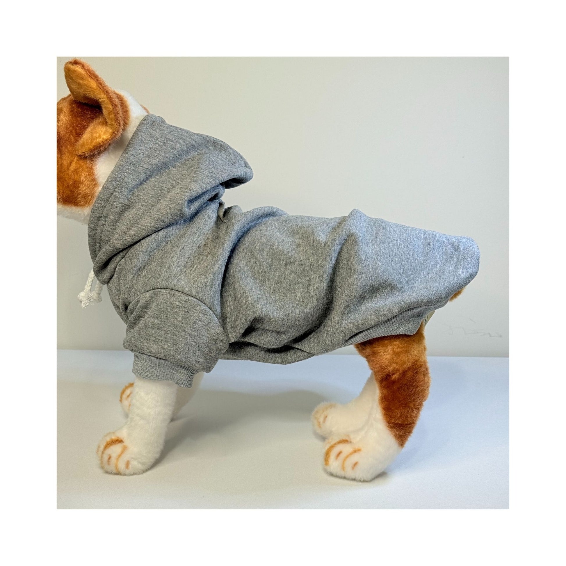 Side view of a plush dog mannequin wearing a grey fleece-lined hoodie, showing full body fit and sleeve length.