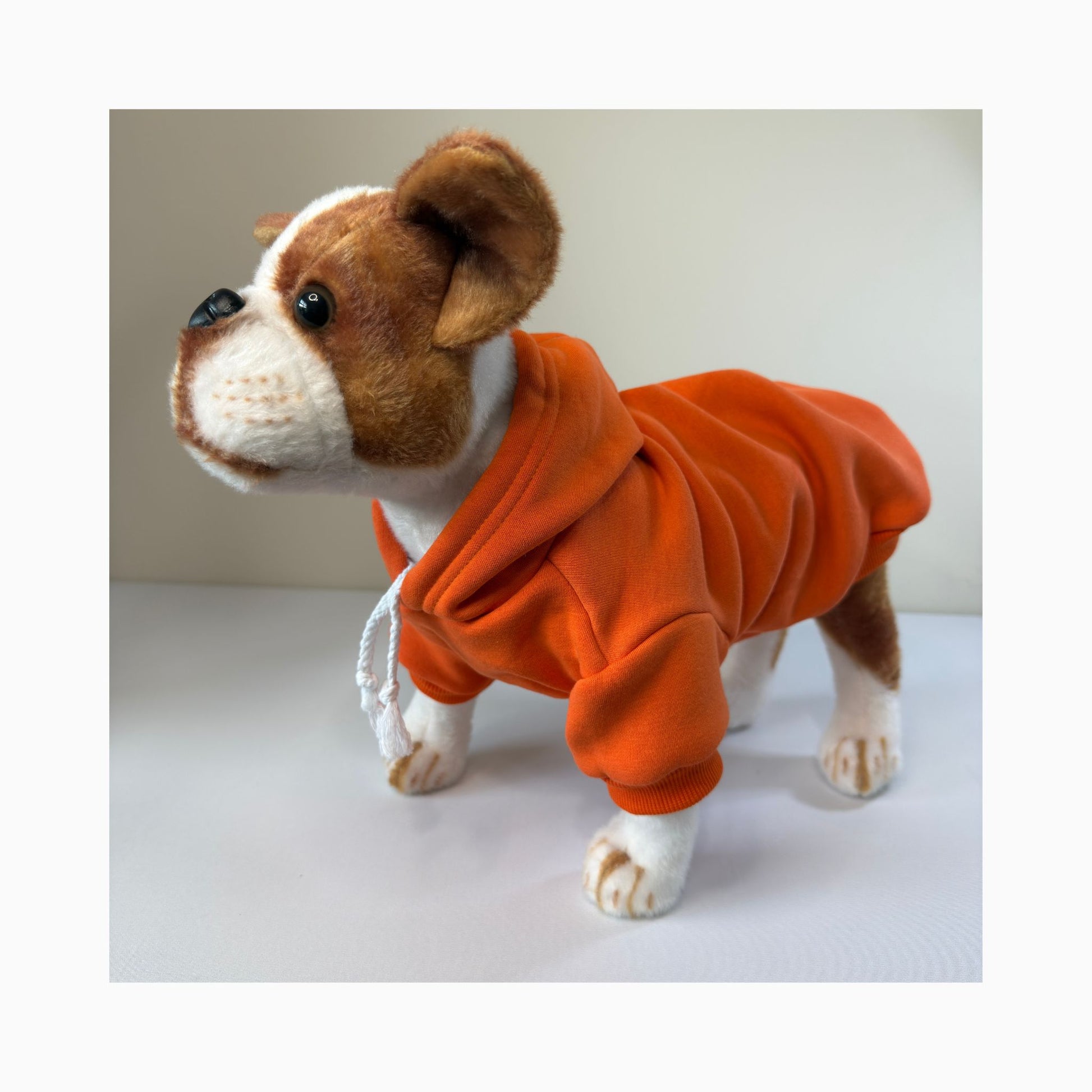 Stuffed dog toy modeling an orange blank dog hoodie - side profile view highlighting fit and color. Great for crafters, small shops, and custom apparel brands.