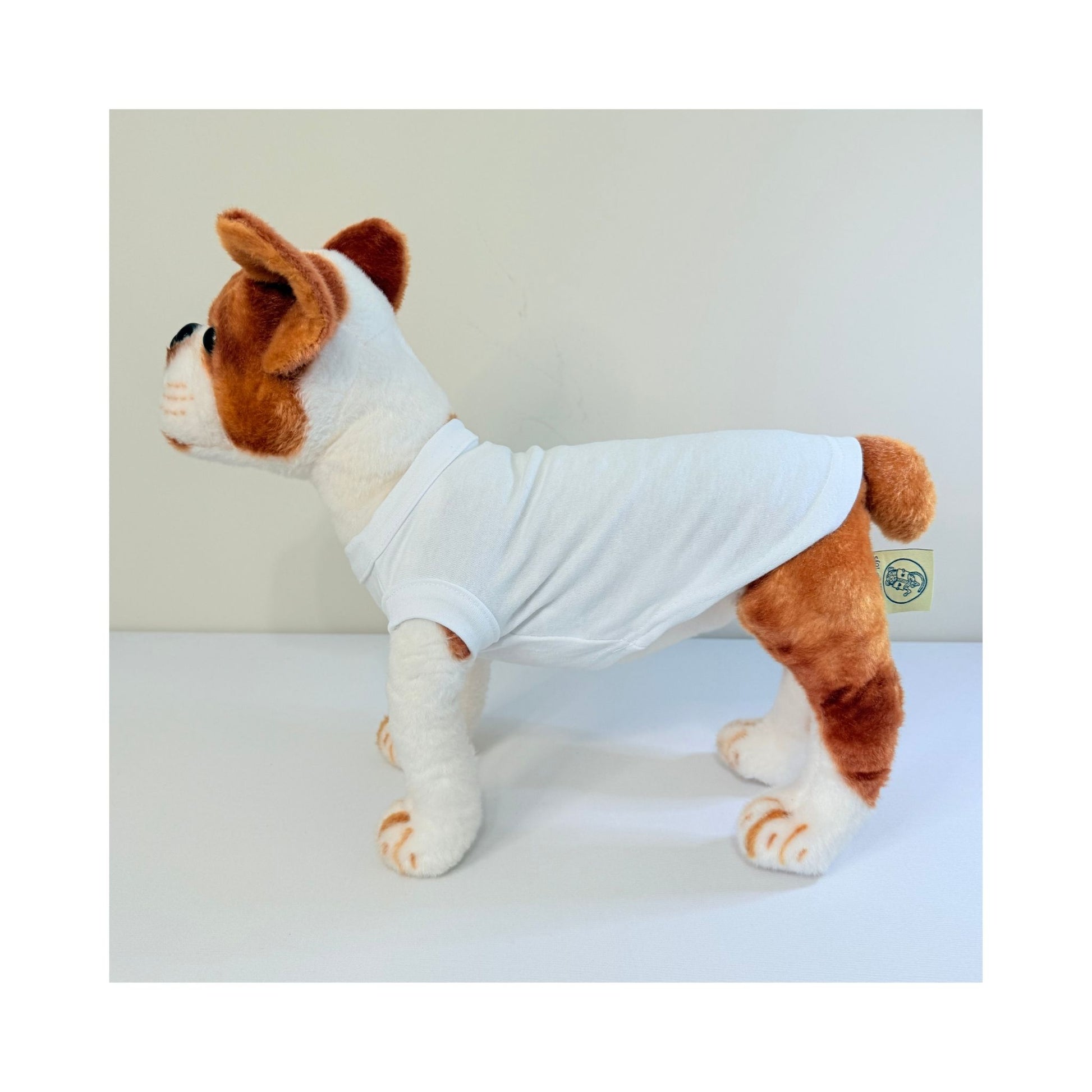 Side profile of stuffed dog wearing a white blank pet t-shirt - full length and fit view
